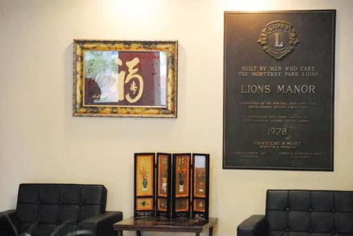 a plaque on the wall of a room with chairs