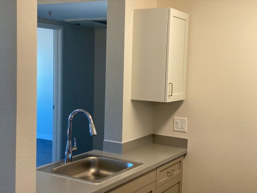 the wall of a bathroom with a urinal and a water fountain