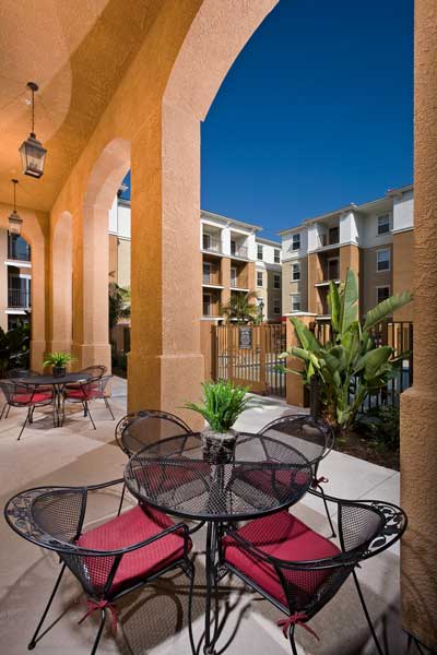 a patio with a table and chairs