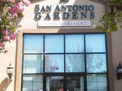 the facade of a building with a sign gardens