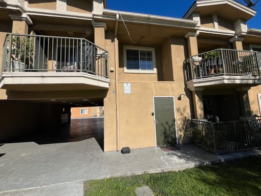 a building with two balconies and a driveway