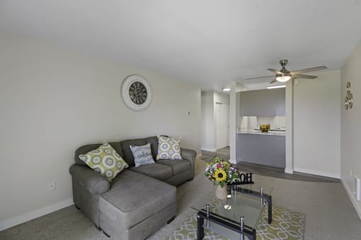 a living room with a couch and coffee table at Campo Basso Apartment Homes, Lynnwood, WA