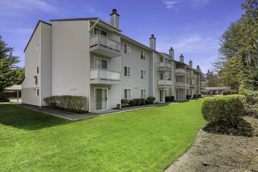 Exterior View of Apartments with Green Grassy Area at Campo Basso Apartment Homes, Lynnwood