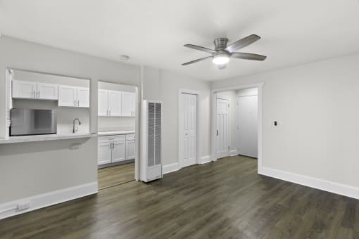 a living room with hardwood floors and white walls at Carolina Court Apartment Homes, Seattle, Washington 98109