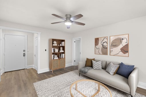 a living room with a couch and a ceiling fan
