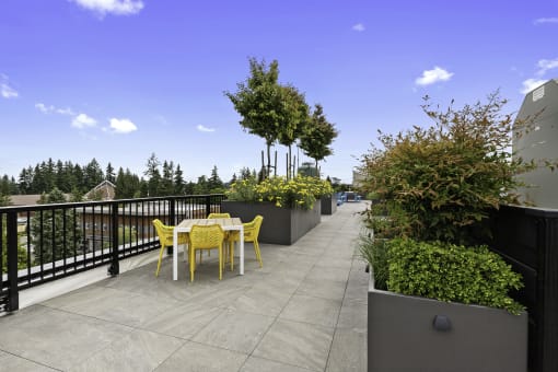 Well Landscaped terrace area with a table and chairs at Arabella Apartment Homes, Shoreline, 98155