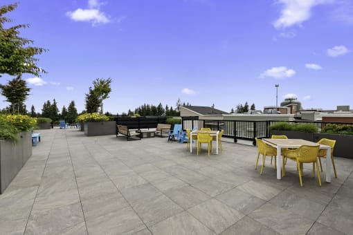 a resident rooftop terrace with tables and chairs at Arabella Apartment Homes, Shoreline, Washington 98155
