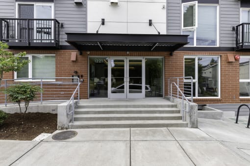 View of the front of the property entrance with a ramp and stairs leading up to the door at Arabella Apartment Homes, Washington