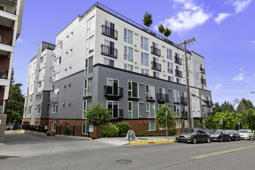 View of the property with grey and brick accents at Arabella Apartment Homes, Shoreline, 98155