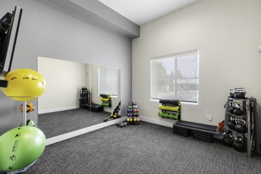 Carpeted Fitness Room with Exercise Balls and Mirrored Wall at Arabella Apartment Homes, Shoreline, Washington 98155