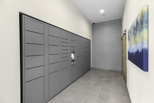 a row of package lockers with a painting on the wall at Arabella Apartment Homes, Shoreline