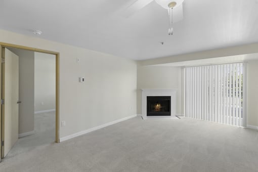 Spacious Living Area with a fireplace, cozy carpeting, and sliding glass doors at Casa Blanca Apartment Homes, Washington