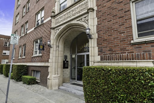 a brick building with an arched doorway  at Charbern Apartment Homes, Seattle, WA, 98122
