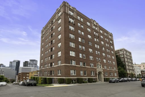 a tall brick building with awnings in front of it at Charbern Apartment Homes, Washington, 98122