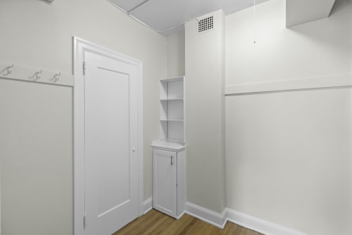 a walk in closet in a bedroom with a white door and white walls at Charbern Apartment Homes, Seattle, Washington