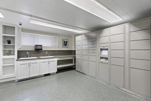 a large room with a Double sink and Package Receiving Lockers at Charbern Apartment Homes, Seattle