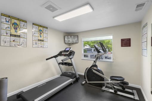 Resident Fitness Facility with exercise equipment and a window at Park Edmonds Apartment Homes, Washington