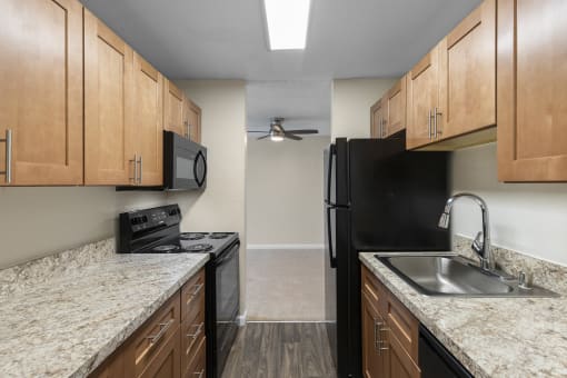 Kitchen with Plank Flooring and Wood Cabinetry at Park Edmonds Apartment Homes, Edmonds, 98026