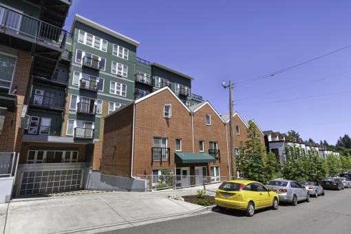 a view from the street of a brick building with a green awning at Sedona Apartments, Seattle