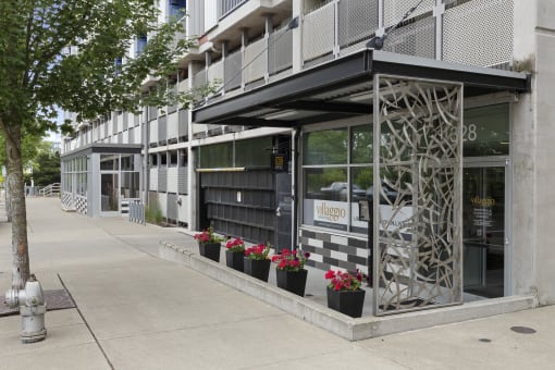 View of the property entrance from the side with artsy iron patio wall at Villaggio Apartment Homes, Tacoma, Washington 98402