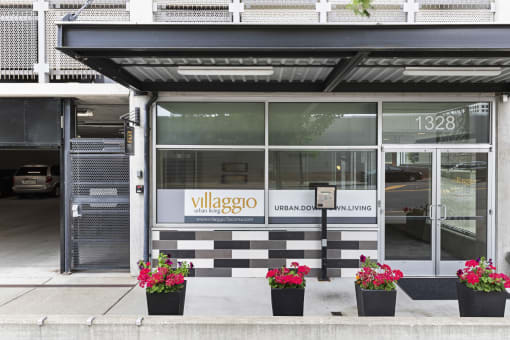 the exterior of the property with a black and white checkered tile and plants in front at Villaggio Apartment Homes, WA 98402