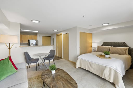 Studio Apartment with Cozy Living Area, Bedroom with Recessed Lighting, and View of Kitchen and Dining Area at Villaggio Apartment Homes, WA 98402