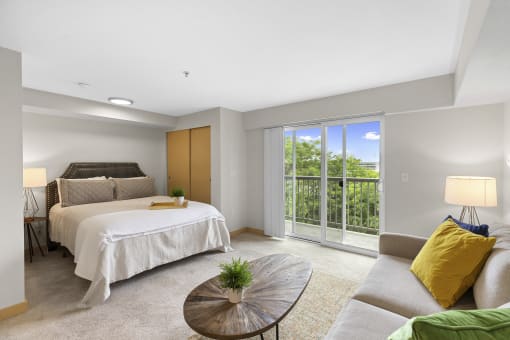 Studio Apartment with Cozy bedroom with a bed and a couch at Villaggio Apartment Homes, Tacoma, WA