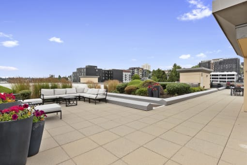 Rooftop Lounge for Residents with couches and tables at Villaggio Apartment Homes, WA 98402