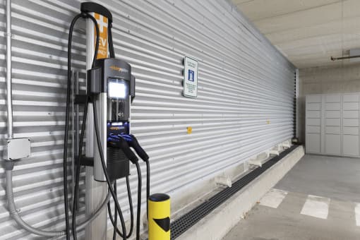 An EV charger in front of a metal wall at Villaggio Apartment Homes, Washington, 98402