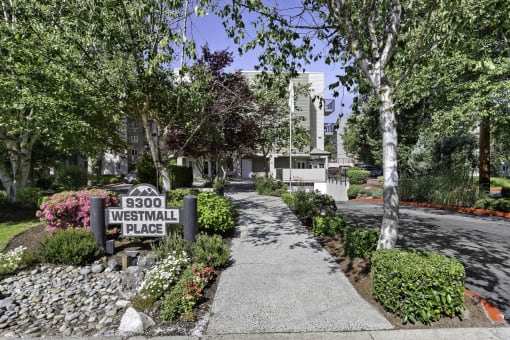 a walkway with small shrubs and property address sign at West Mall Place Apartment Homes, Everett, WA, 98208