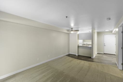 Unfurnished living area with a view into the kitchen in the background  at West Mall Place Apartment Homes, Washington