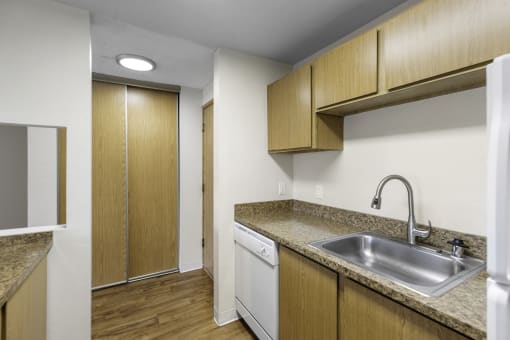 a kitchen with a sink and a dishwasher at Willows Court Apartment Homes, Seattle, Washington 98125