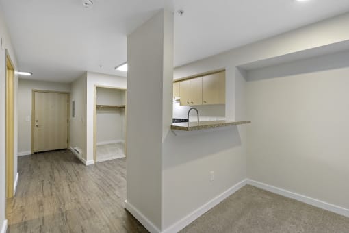 Living Room View with Breakfast Bar and Plank Flooring at Excalibur Apartment Homes, Washington, 98004