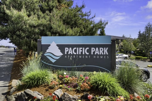 Pacific Park Apartment Homes Welcome Sign with Landscaping Plants Below at Pacific Park Apartment Homes, Edmonds, WA