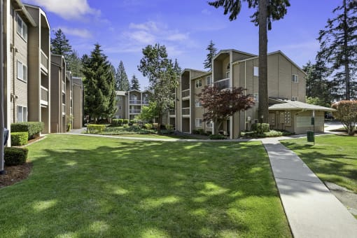 Apartment Buildings Surrounded by Grassy Area with Trees at Park 210 Apartment Homes, Washington, 98026