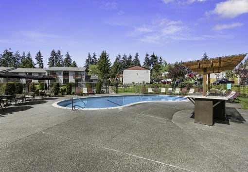 Sparkling Outdoor Pool and Hot Tub with Trees in the Background at Pinewood Square Apartment Homes, Lynnwood, Washington 98087