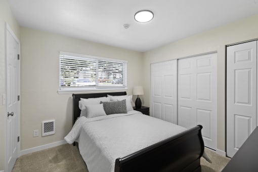 Spacious Bedroom with Large Closet, Plush Carpeting, and Overhead Lighting at Pinewood Square Apartment Homes, Washington