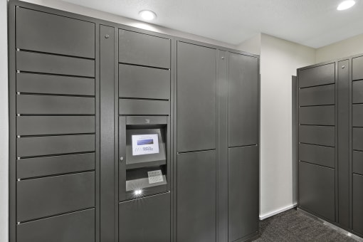 a row of package receiving lockers in the resident package room at Pinewood Square Apartment Homes, Lynnwood