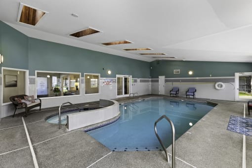 blue indoor swimming pool with a spacious hot tub at Serra Vista Apartment Homes, Washington