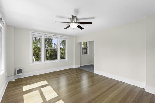 a living room with hardwood floors and a ceiling fan at Stockbridge Apartment Homes, WA 98101