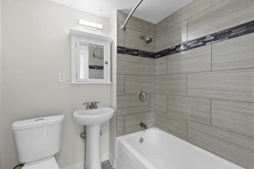 Bathroom with Wide Tiled Shower and Above Sink Mirror at Stockbridge Apartment Homes, Seattle