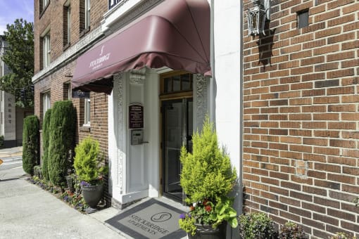 Property Entrance of brick building with a red awning at Stockbridge Apartment Homes, Washington