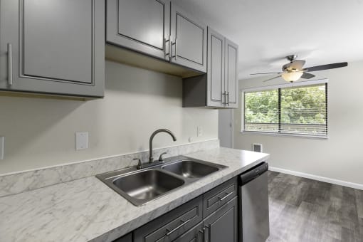 kitchen with Grey Cabinetry and Plank Flooring at Swiss Gables Apartment Homes, Kent