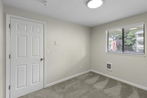 Living Room with a white door and a window at Swiss Gables Apartment Homes, Kent, Washington 98032