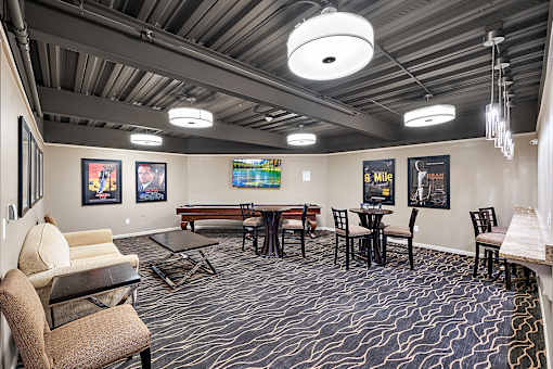A room with a patterned carpet and a long table with chairs at MainCentre, Northville