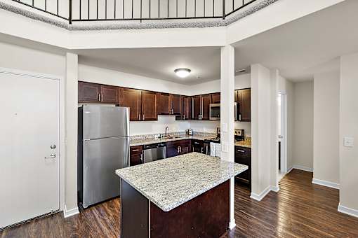 A kitchen with a marble island in the middle of the room at MainCentre, Northville
