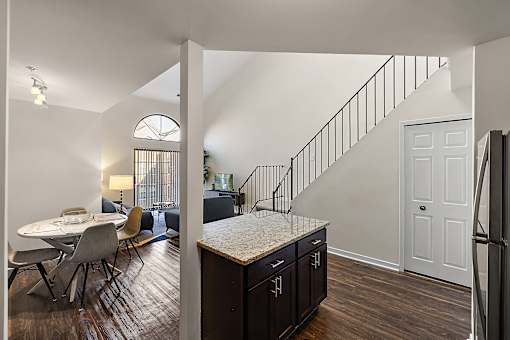 A kitchen with a table and chairs is visible from the dining room at MainCentre, Northville