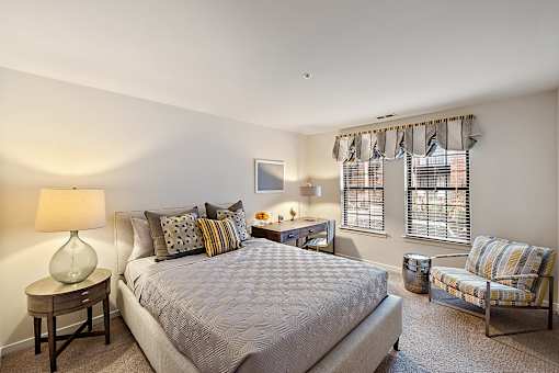 A bedroom with a large bed and a chair at MainCentre, Northville