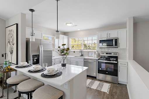 A modern kitchen with a breakfast table set for two at Briarcliff Village, Michigan, 48390