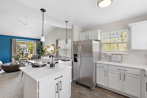 A modern kitchen with a stainless steel refrigerator and white cabinets at Briarcliff Village, Michigan, 48390